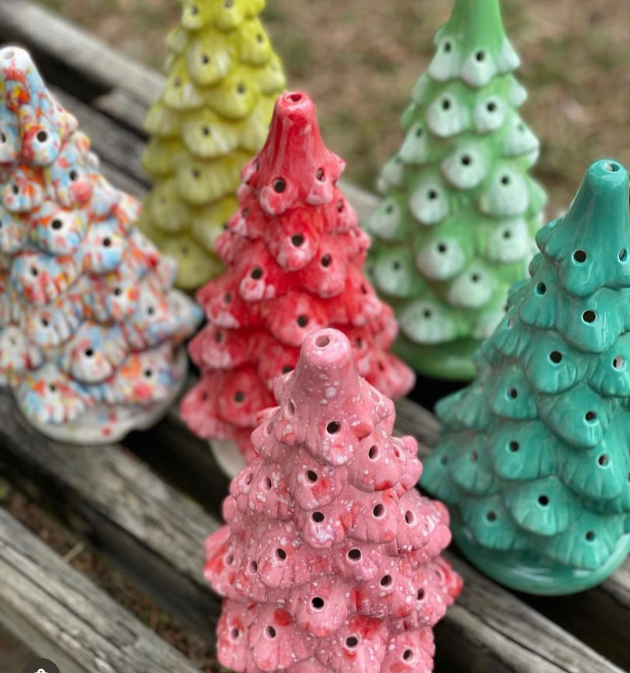 Ceramic Christmas trees painted a variety of greens and reds.